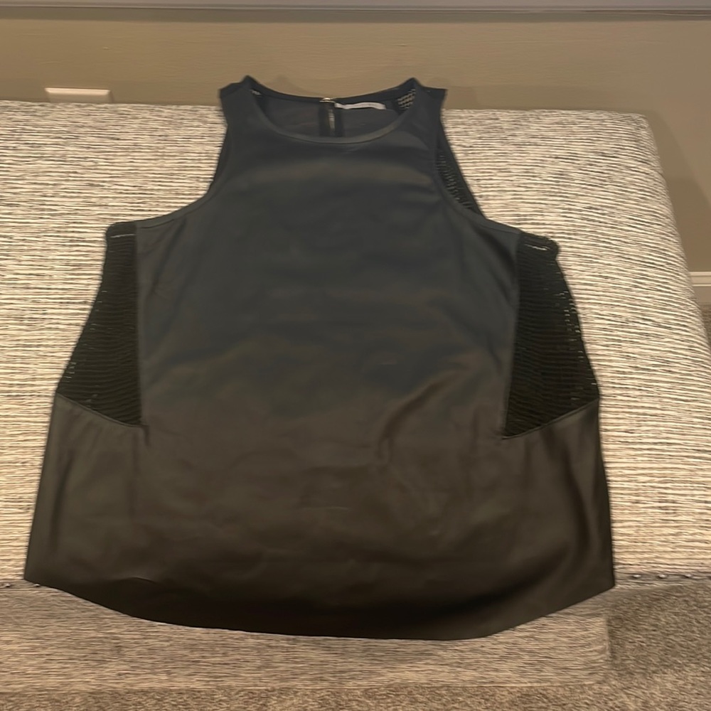 Tobi black faux leather tank. Netting in the sides. Clip closure in the back.